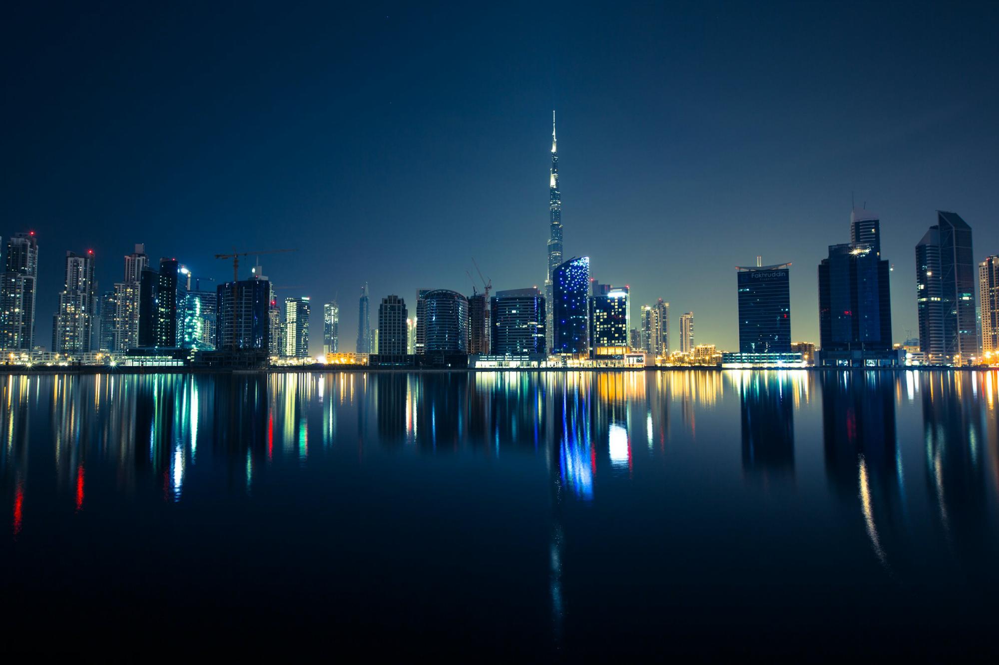 Business Bay skyline at night reflected in the water