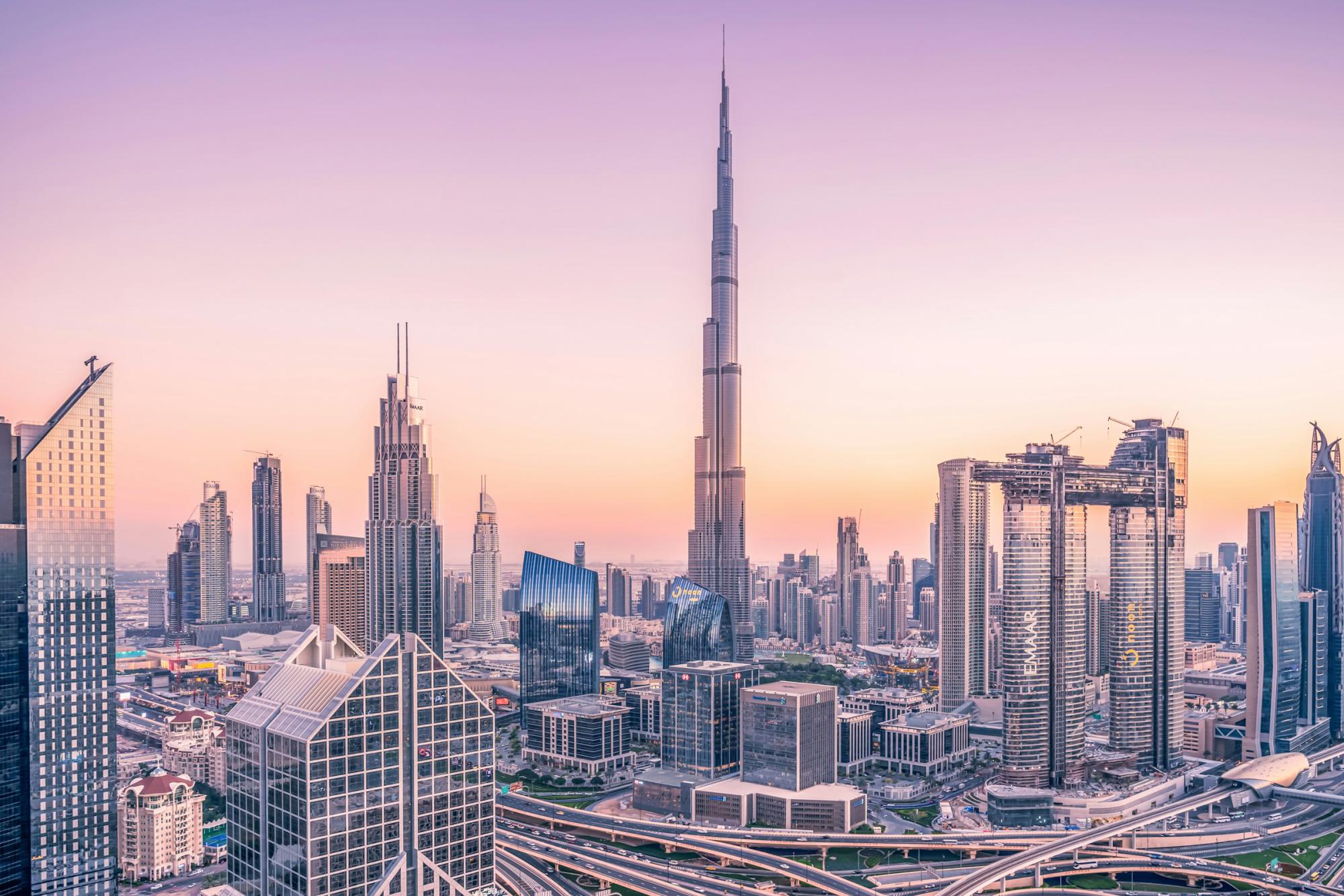 Downtown Dubai and the Burj Khalifa at dusk under a lilac sky